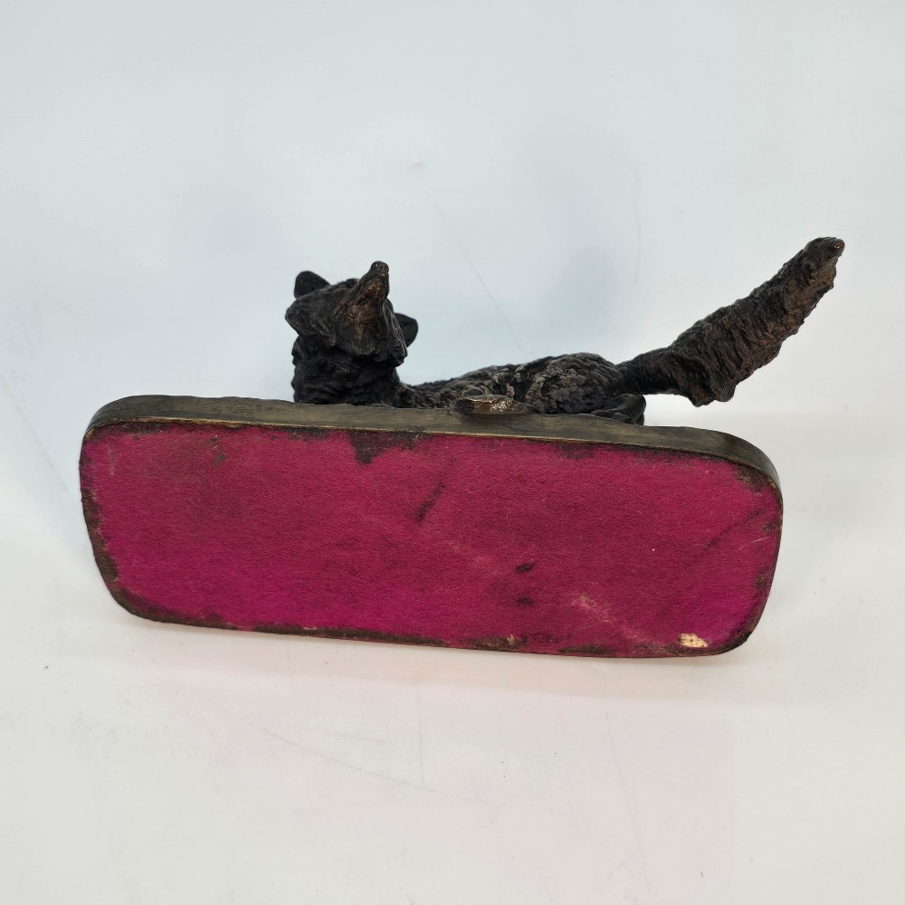A dark brown patinated bronze sculpture depicting a crouching fox on a naturalistic textured base. View IX