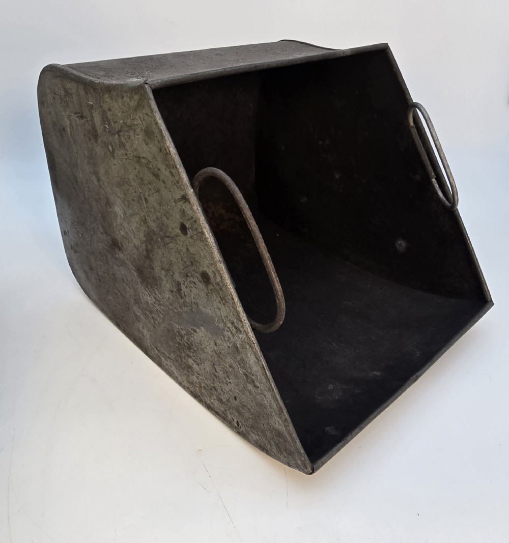 Victorian sloped brass coal box featuring repousse sunflower motifs, turned brass feet, and a top carrying handle with an integrated rear shovel. View XIII
