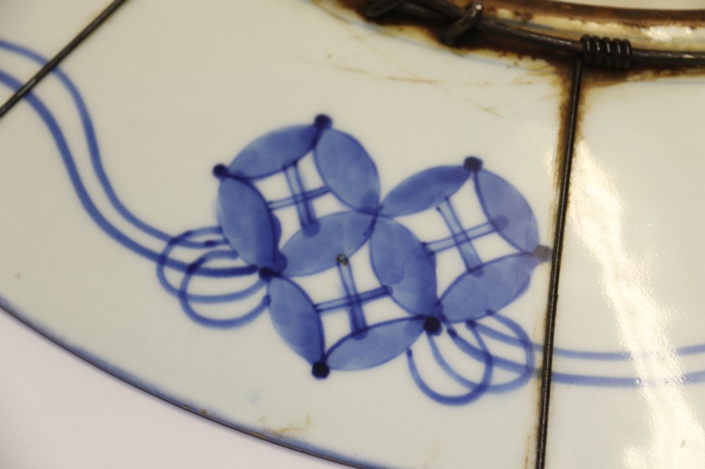 A circular antique Japanese porcelain charger plate with hand-painted cobalt blue, iron red, and gilded decoration featuring birds, goldfish, and floral patterns. View XI