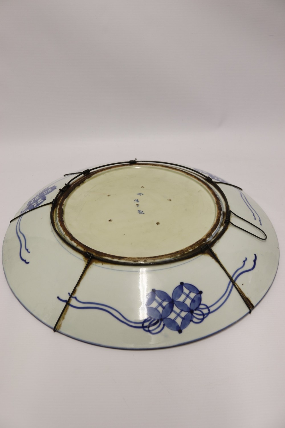 A circular antique Japanese porcelain charger plate with hand-painted cobalt blue, iron red, and gilded decoration featuring birds, goldfish, and floral patterns. View XIII