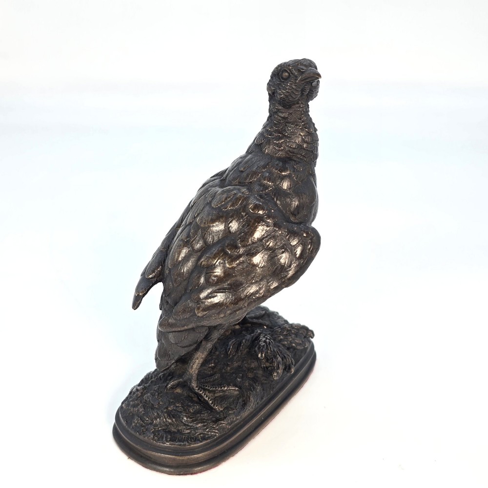 A nineteenth-century dark patinated bronze sculpture of a partridge standing on an integral naturalistic base. View II