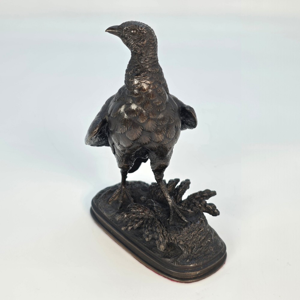 A nineteenth-century dark patinated bronze sculpture of a partridge standing on an integral naturalistic base. View III