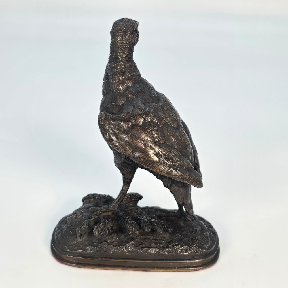 A nineteenth-century dark patinated bronze sculpture of a partridge standing on an integral naturalistic base. View V