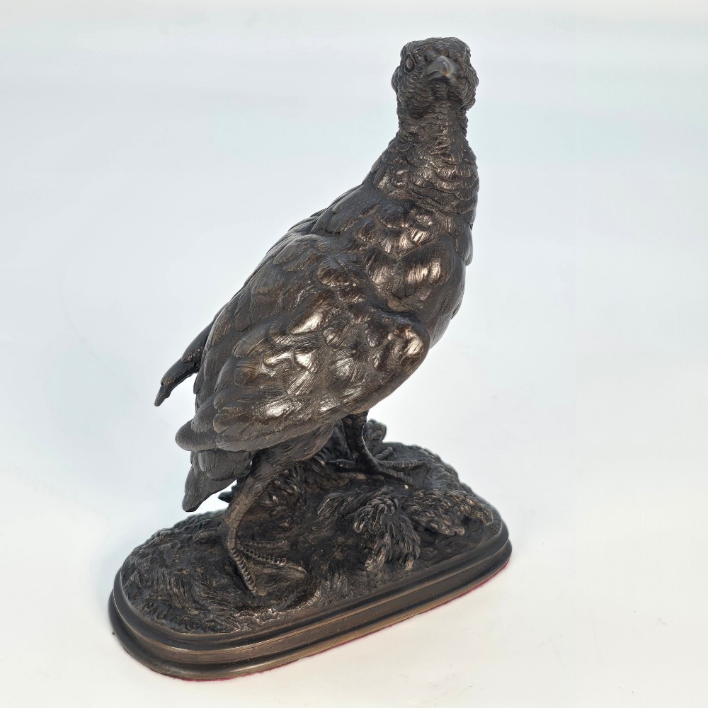 A nineteenth-century dark patinated bronze sculpture of a partridge standing on an integral naturalistic base. View VII