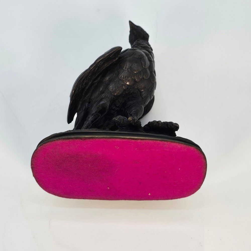 A nineteenth-century dark patinated bronze sculpture of a partridge standing on an integral naturalistic base. View IX
