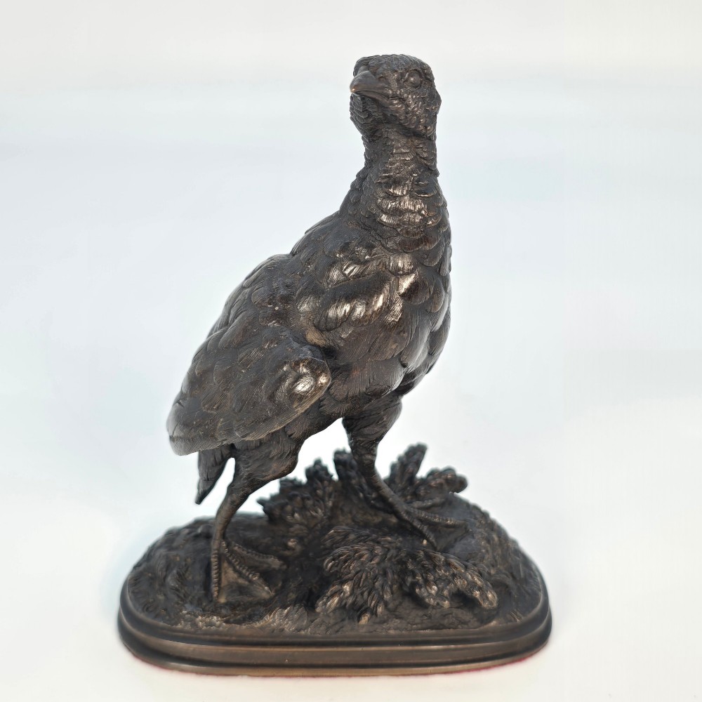 A nineteenth-century dark patinated bronze sculpture of a partridge standing on an integral naturalistic base. View X
