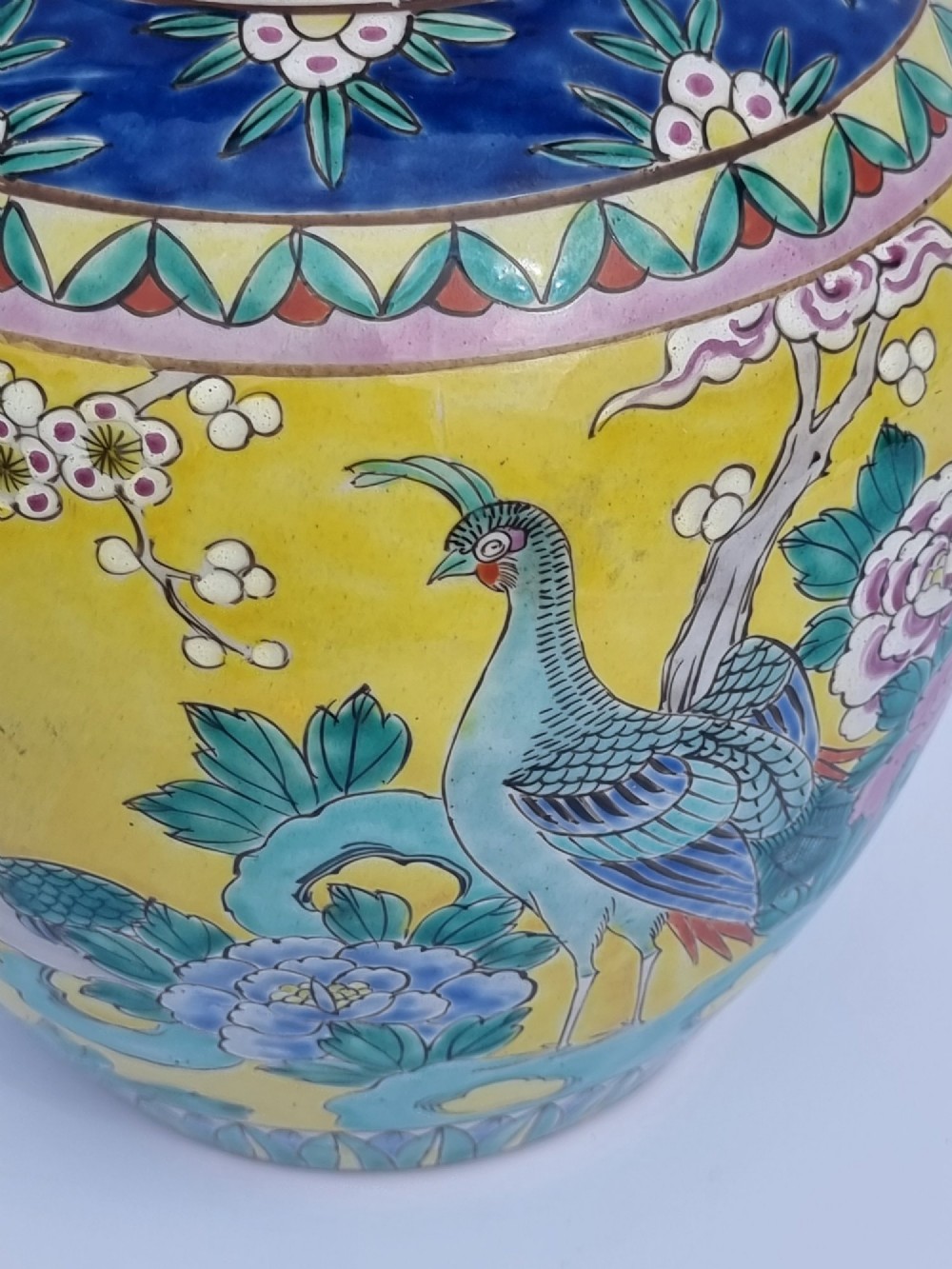 A pair of hand-painted Chinese porcelain ginger jars featuring yellow grounds decorated with pheasants and peonies, capped with blue patterned lids. View XI
