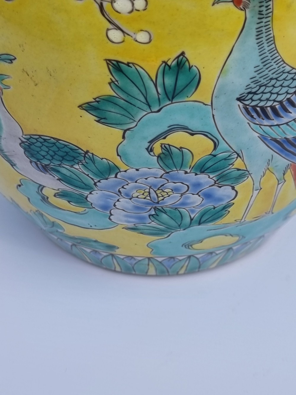 A pair of hand-painted Chinese porcelain ginger jars featuring yellow grounds decorated with pheasants and peonies, capped with blue patterned lids. View XII