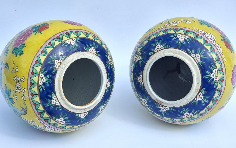 A pair of hand-painted Chinese porcelain ginger jars featuring yellow grounds decorated with pheasants and peonies, capped with blue patterned lids. View XIII