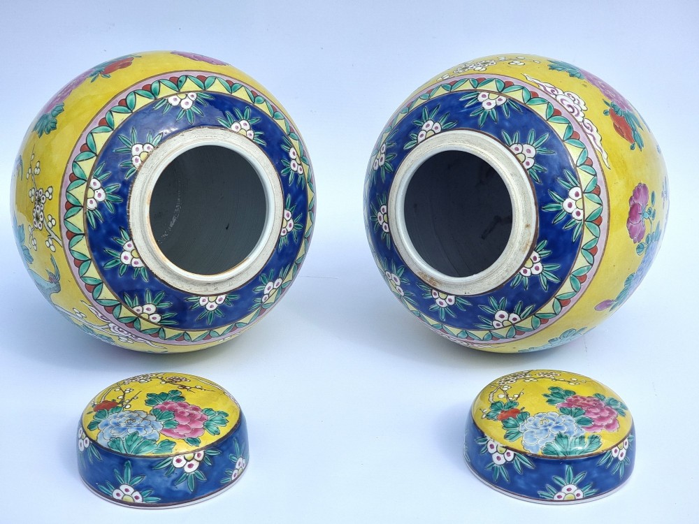A pair of hand-painted Chinese porcelain ginger jars featuring yellow grounds decorated with pheasants and peonies, capped with blue patterned lids. View XIV