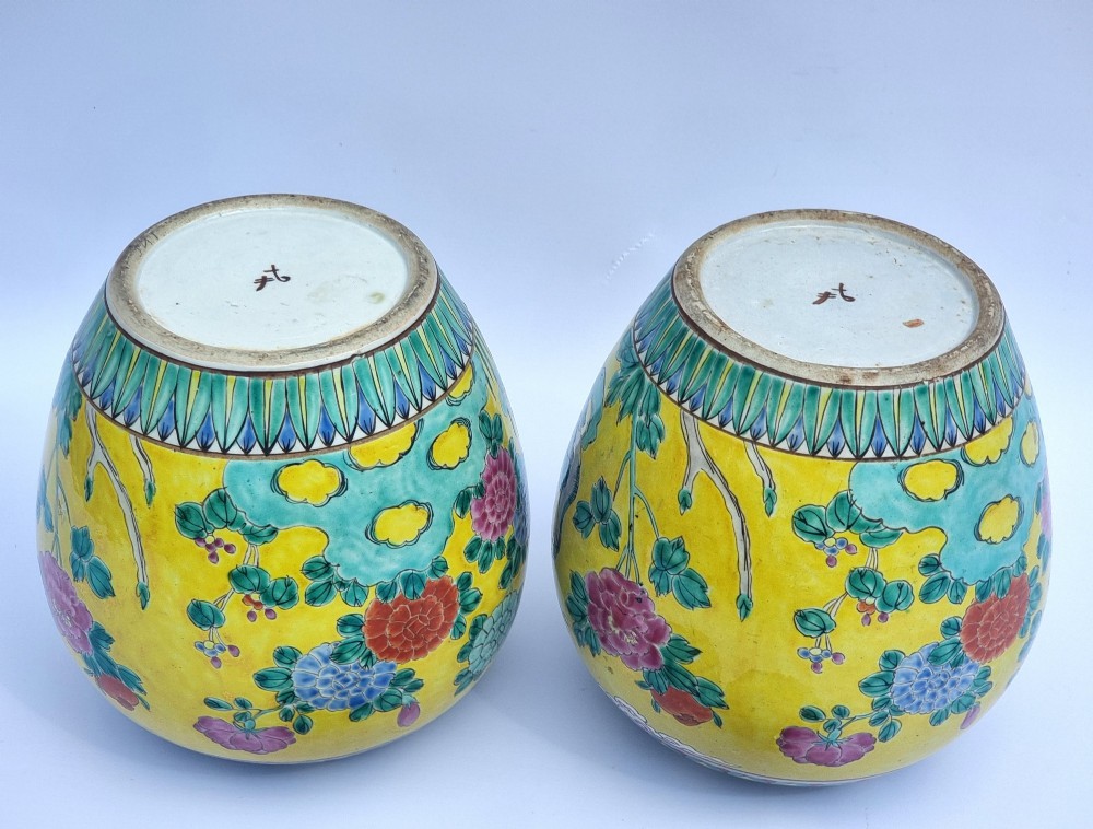 A pair of hand-painted Chinese porcelain ginger jars featuring yellow grounds decorated with pheasants and peonies, capped with blue patterned lids. View XV
