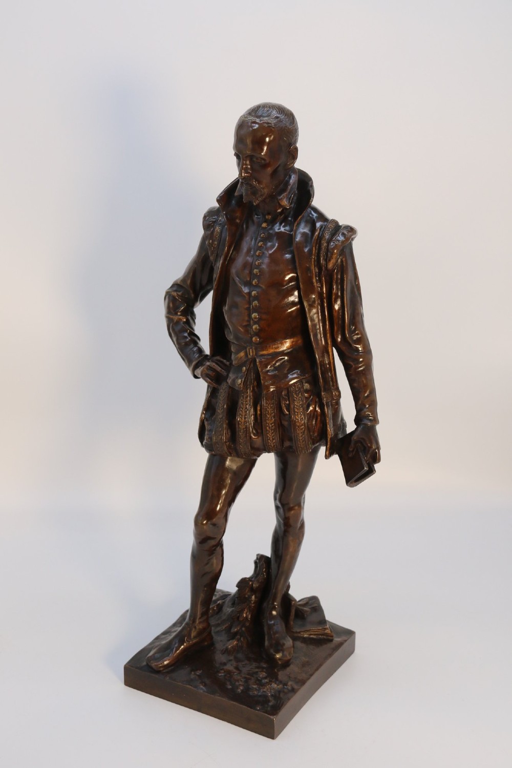 A 19th-century patinated bronze standing figure depicting a Renaissance poet in detailed attire, mounted on a rectangular bronze base. View III