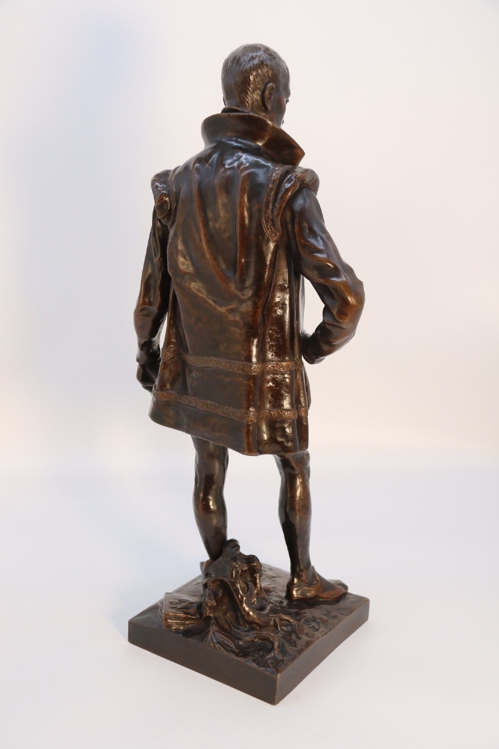 A 19th-century patinated bronze standing figure depicting a Renaissance poet in detailed attire, mounted on a rectangular bronze base. View VIII