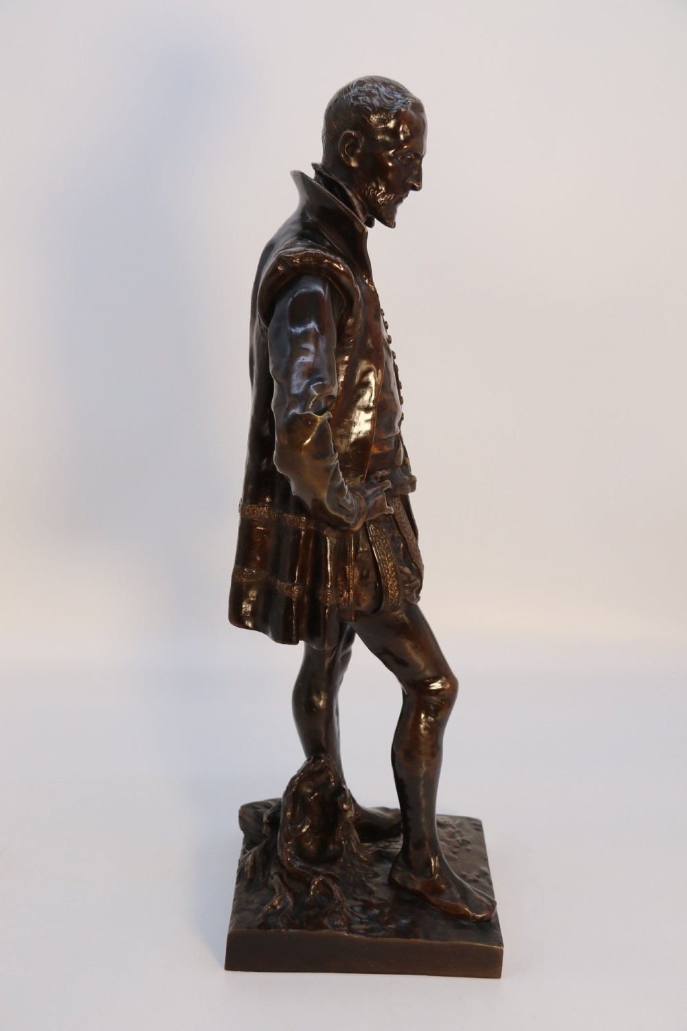 A 19th-century patinated bronze standing figure depicting a Renaissance poet in detailed attire, mounted on a rectangular bronze base. View IX
