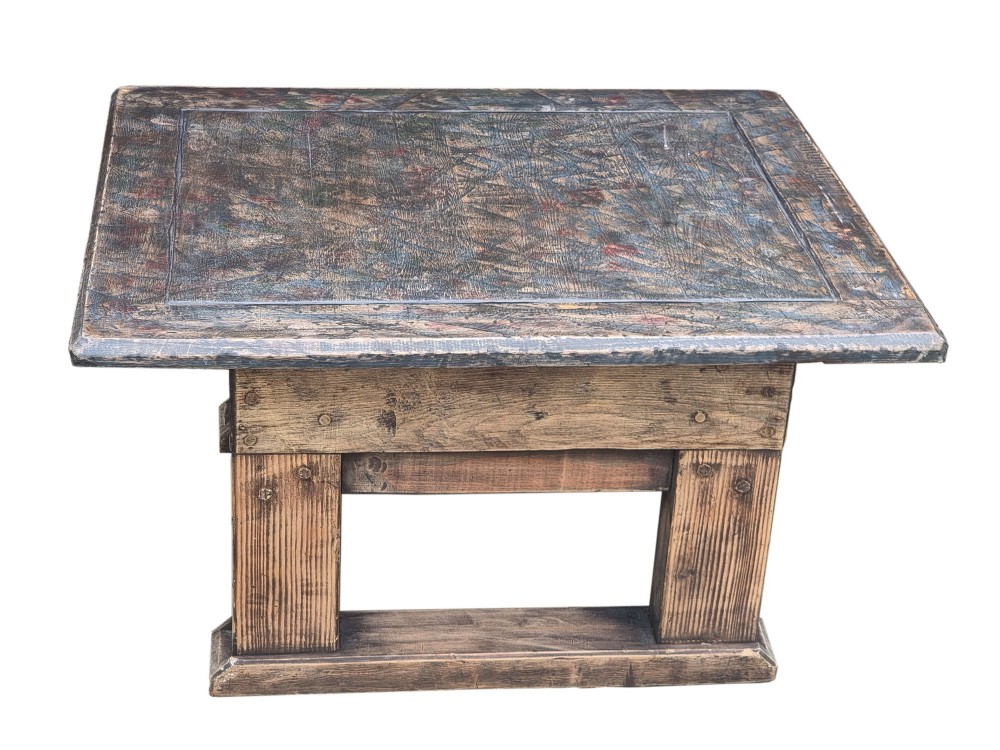 A low rectangular rustic oak table featuring a heavily distressed painted top with linear detailing supported by thick trestle legs. View II