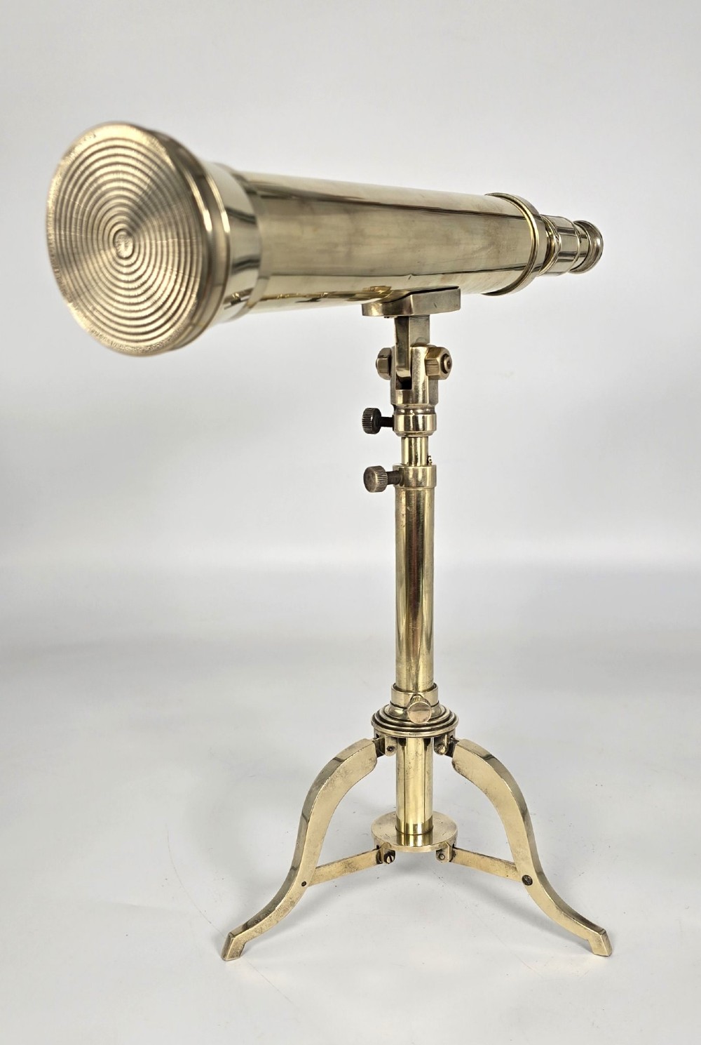 A Victorian brass tabletop telescope mounted on an adjustable folding brass tripod stand. View V