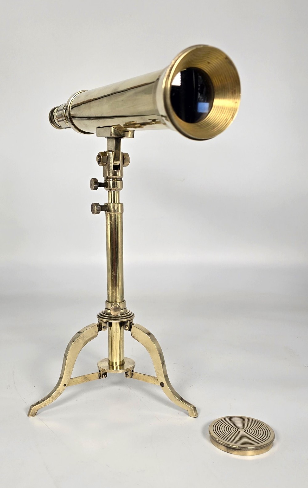 A Victorian brass tabletop telescope mounted on an adjustable folding brass tripod stand. View VI