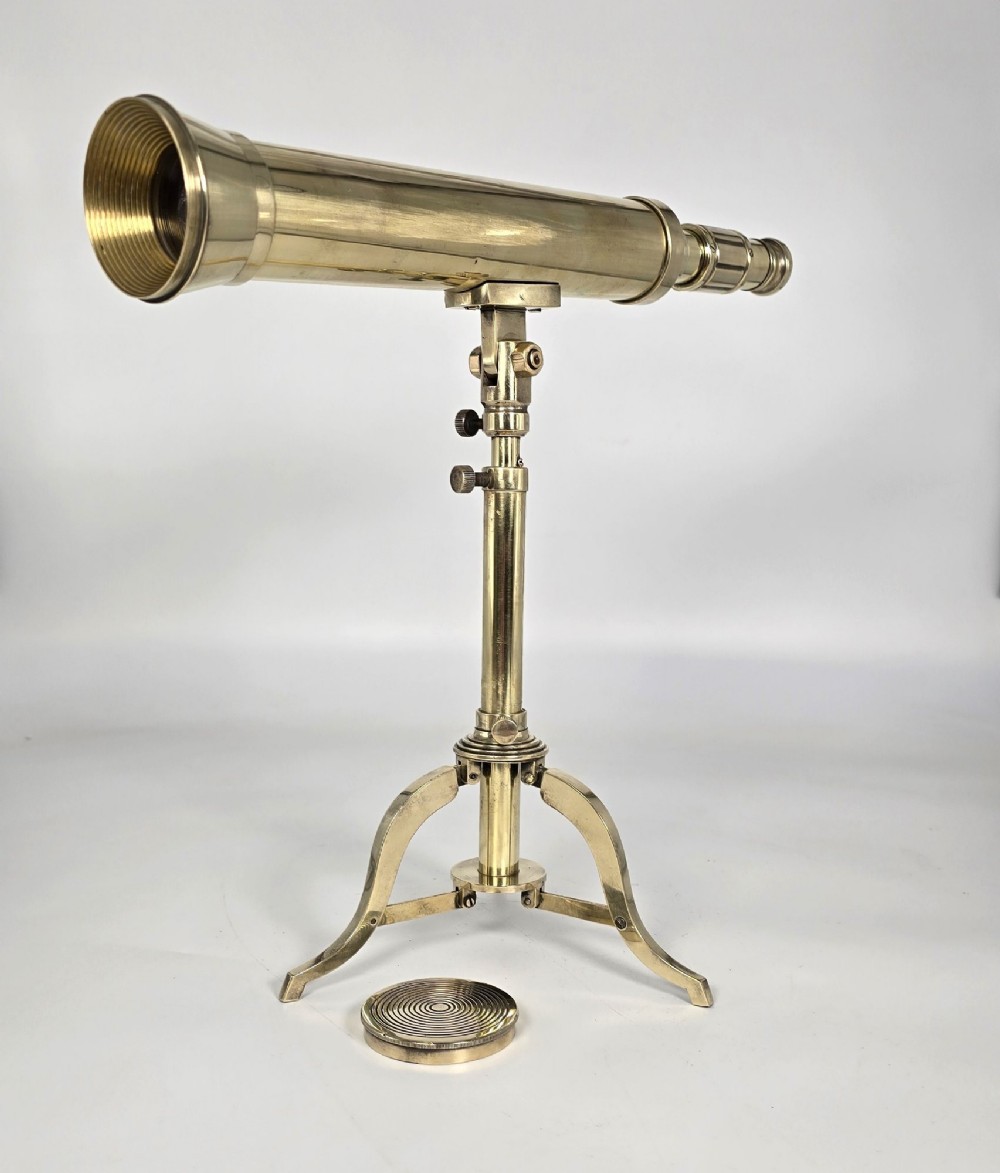 A Victorian brass tabletop telescope mounted on an adjustable folding brass tripod stand. View VIII