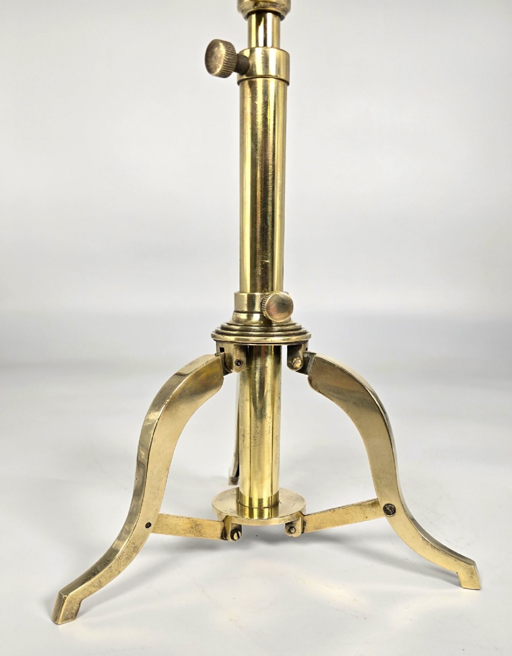 A Victorian brass tabletop telescope mounted on an adjustable folding brass tripod stand. View IX
