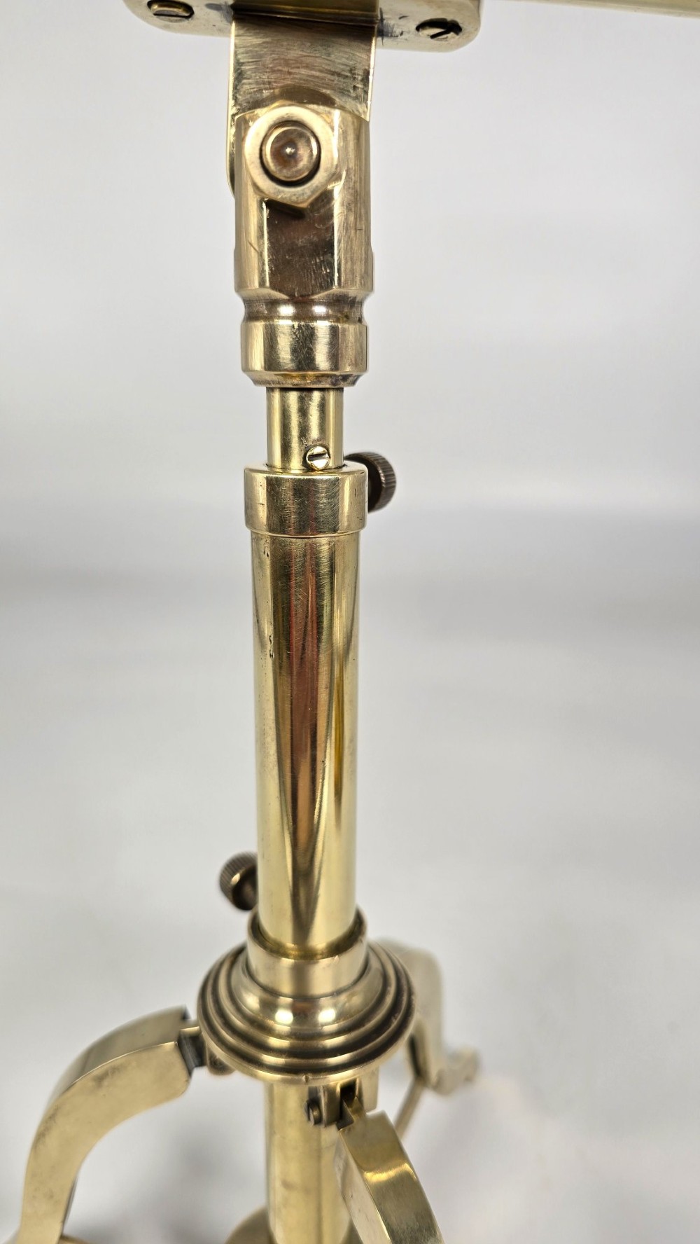 A Victorian brass tabletop telescope mounted on an adjustable folding brass tripod stand. View XIV