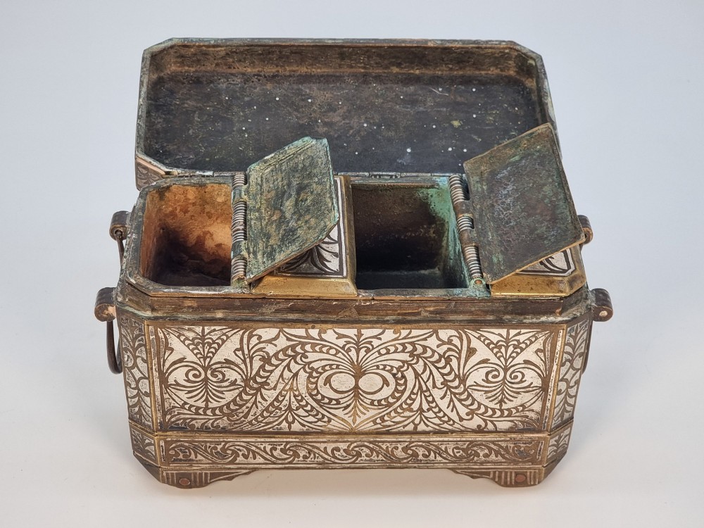A rectangular dark bronze betel box embellished with detailed silver floral scrollwork inlay and featuring side handles. View VII