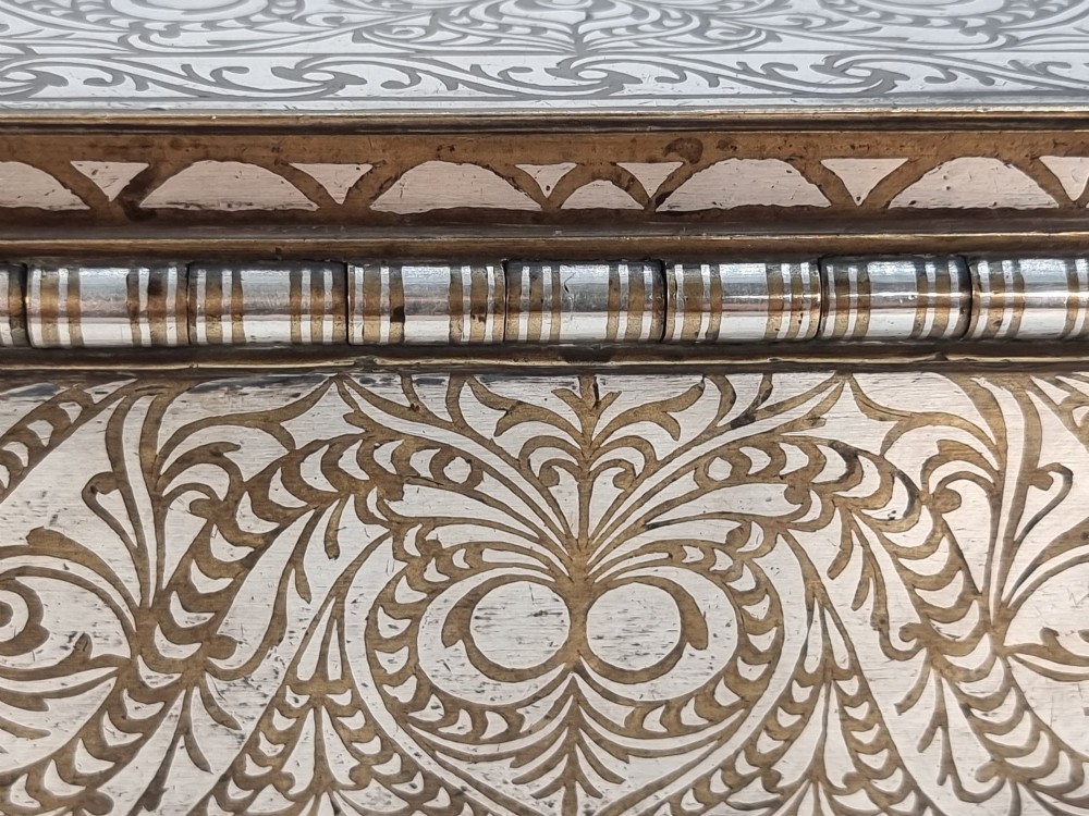 A rectangular dark bronze betel box embellished with detailed silver floral scrollwork inlay and featuring side handles. View XIV