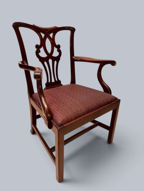 fig 1. A pair of 19th-century mahogany Chippendale style armchairs featuring carved pierced splat backs, curving armrests, and patterned fabric seats.