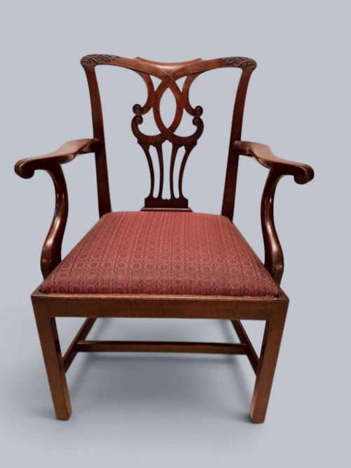 fig 2. A pair of 19th-century mahogany Chippendale style armchairs featuring carved pierced splat backs, curving armrests, and patterned fabric seats.