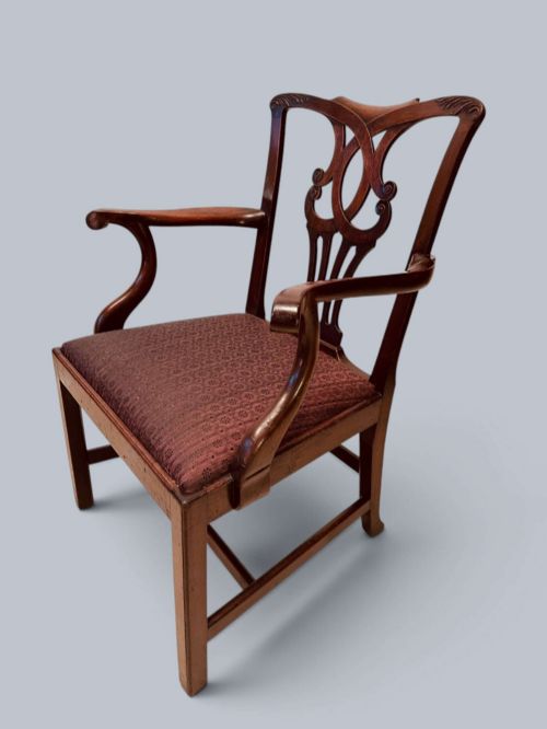 fig 3. A pair of 19th-century mahogany Chippendale style armchairs featuring carved pierced splat backs, curving armrests, and patterned fabric seats.