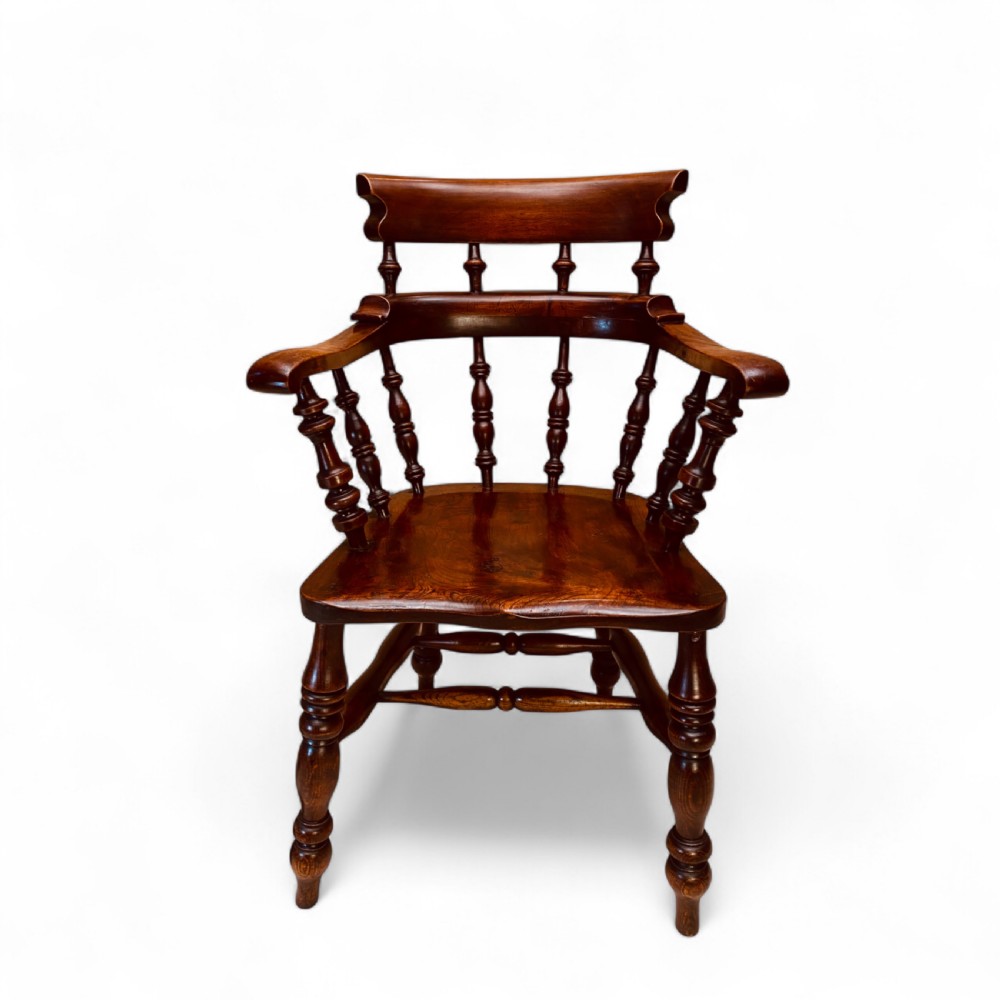 A set of sixteen matching comb back wooden Windsor armchairs made from brown ash and alder wood featuring turned spindles and shaped crest rails. View III