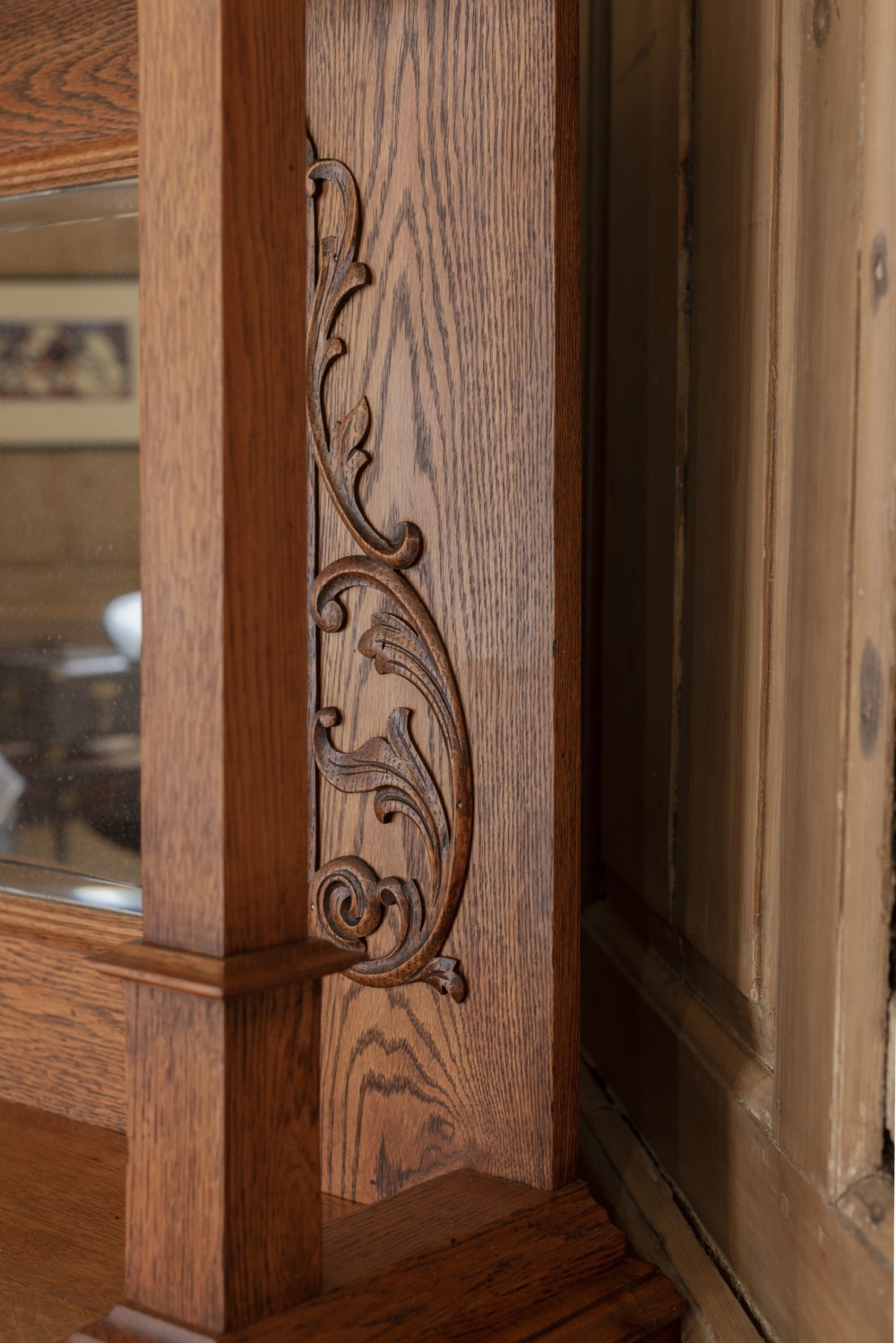 An antique Art Nouveau oak dresser featuring a mirrored upper tier with carved accents and a lower cabinet base with iron hardware. View VIII
