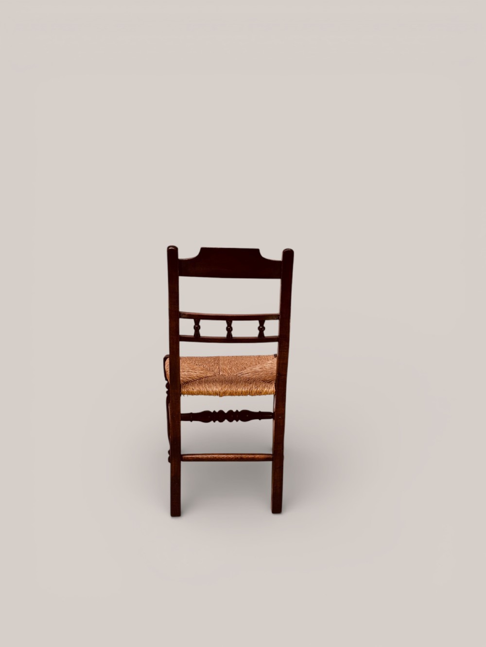 A set of dark ash and alder wood dining chairs featuring hand-woven rush seats, turned front legs, and decorative back spindles. View VIII