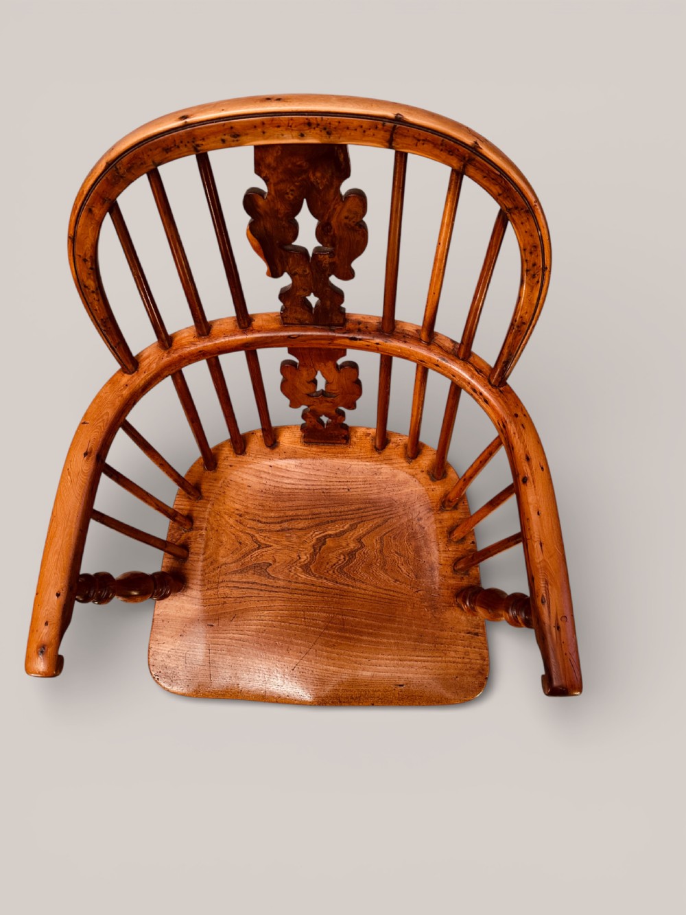 A Victorian 19th-century Windsor low back armchair constructed from yew and elm wood featuring turned legs, a pierced splat, and a contoured saddle seat. View III