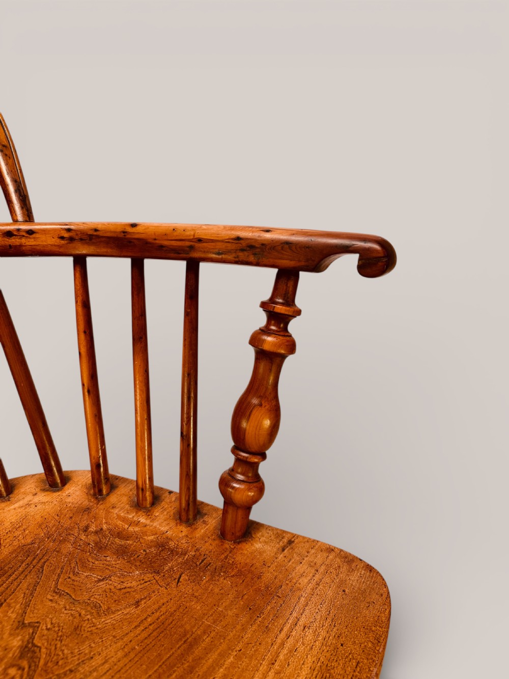 A Victorian 19th-century Windsor low back armchair constructed from yew and elm wood featuring turned legs, a pierced splat, and a contoured saddle seat. View IX