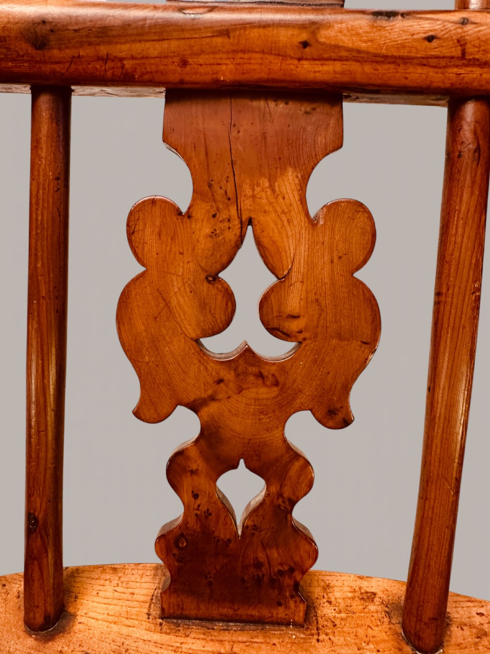 A Victorian 19th-century Windsor low back armchair constructed from yew and elm wood featuring turned legs, a pierced splat, and a contoured saddle seat. View XI