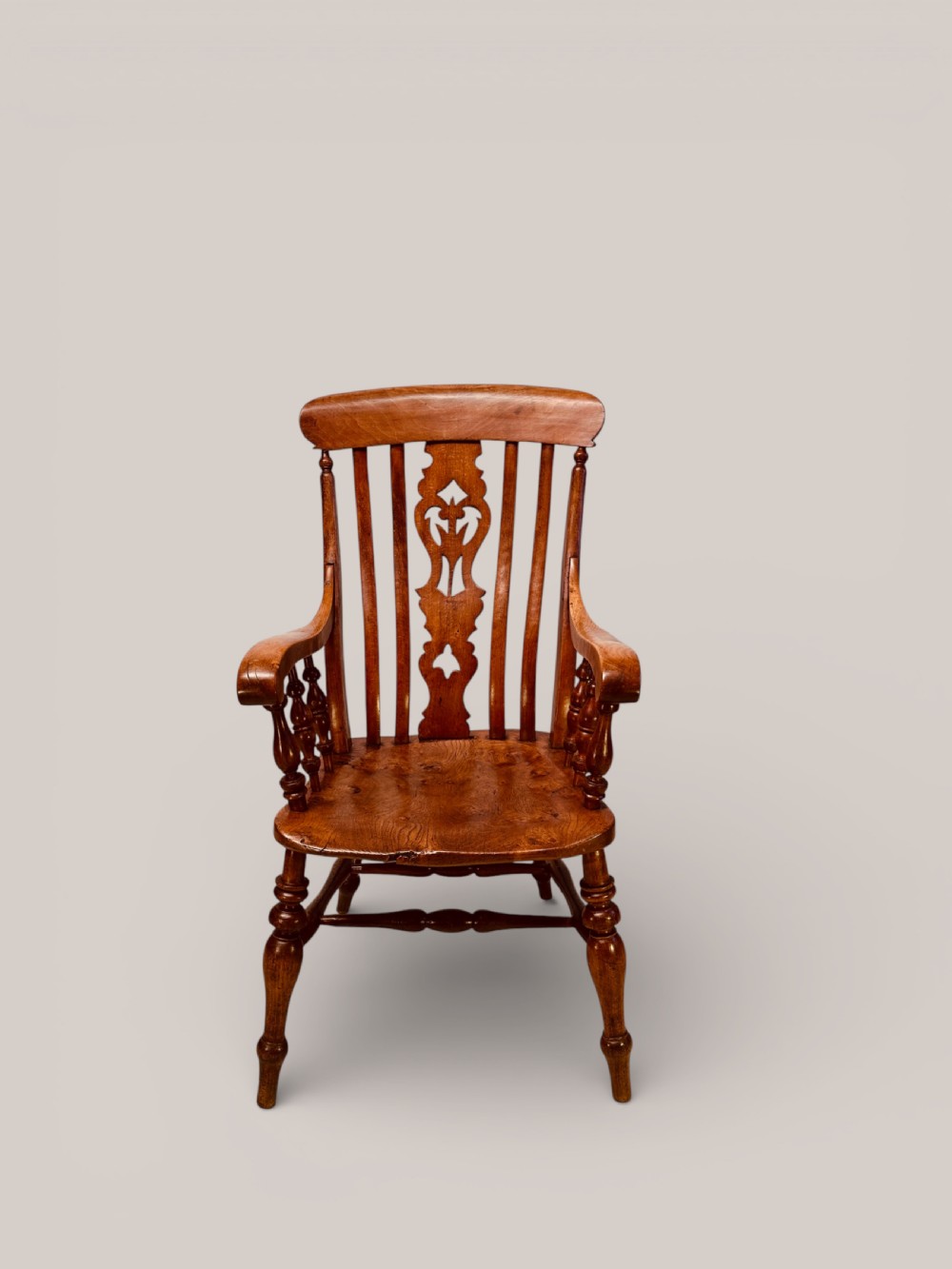 A Victorian Windsor armchair crafted from beech and elm with a pierced back splat, turned legs, and curved armrests. View III
