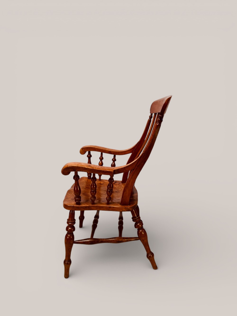 A Victorian Windsor armchair crafted from beech and elm with a pierced back splat, turned legs, and curved armrests. View IV