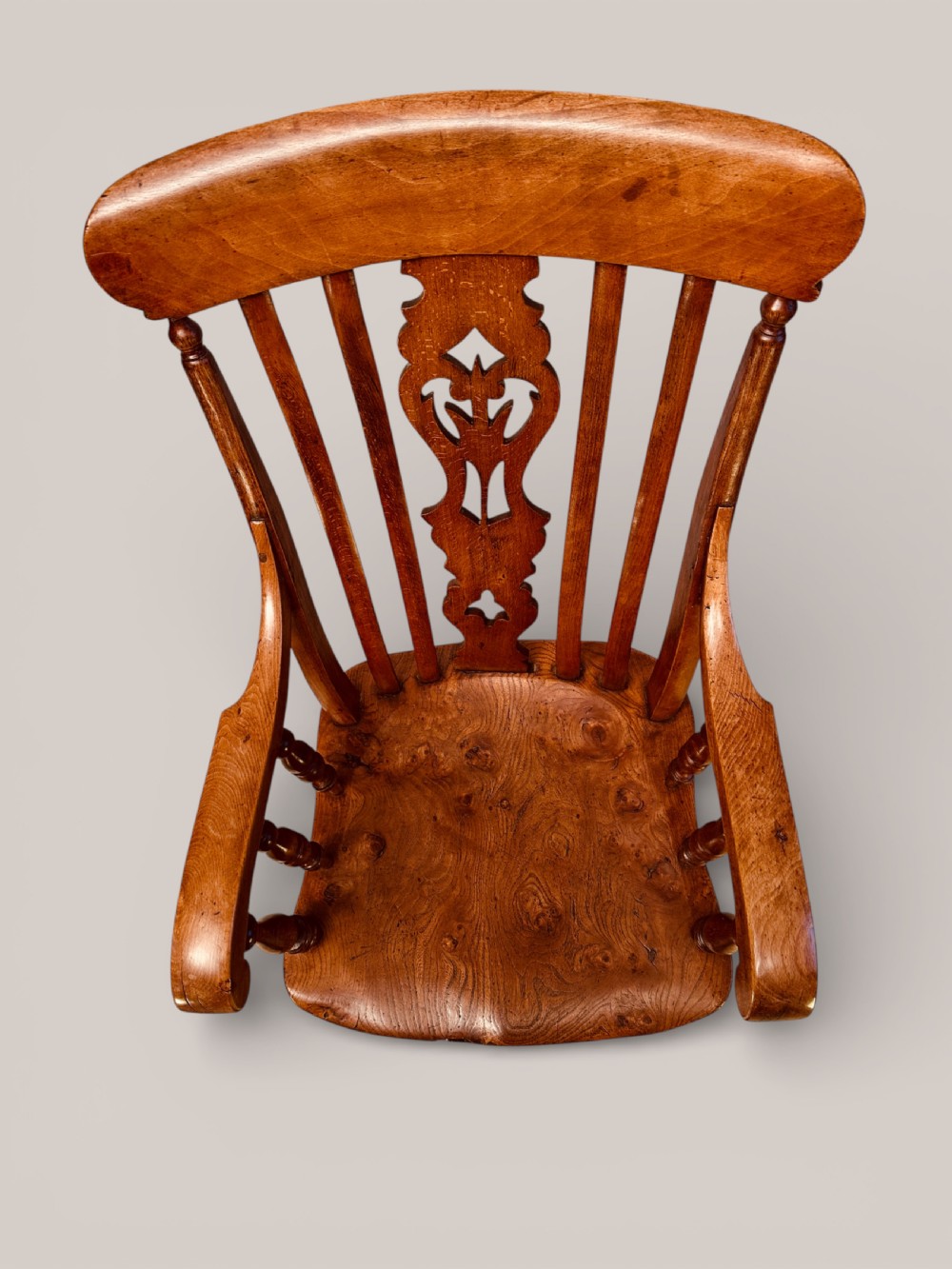 A Victorian Windsor armchair crafted from beech and elm with a pierced back splat, turned legs, and curved armrests. View VII