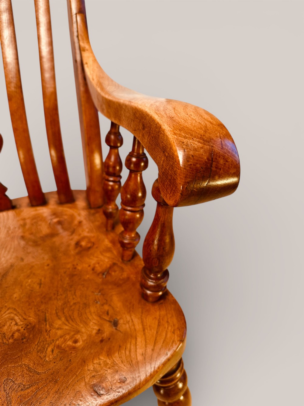 A Victorian Windsor armchair crafted from beech and elm with a pierced back splat, turned legs, and curved armrests. View VIII