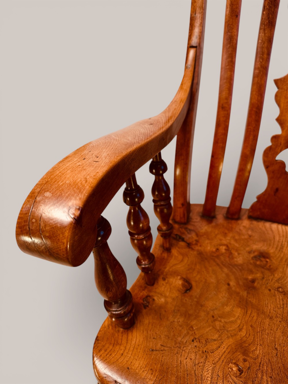A Victorian Windsor armchair crafted from beech and elm with a pierced back splat, turned legs, and curved armrests. View IX