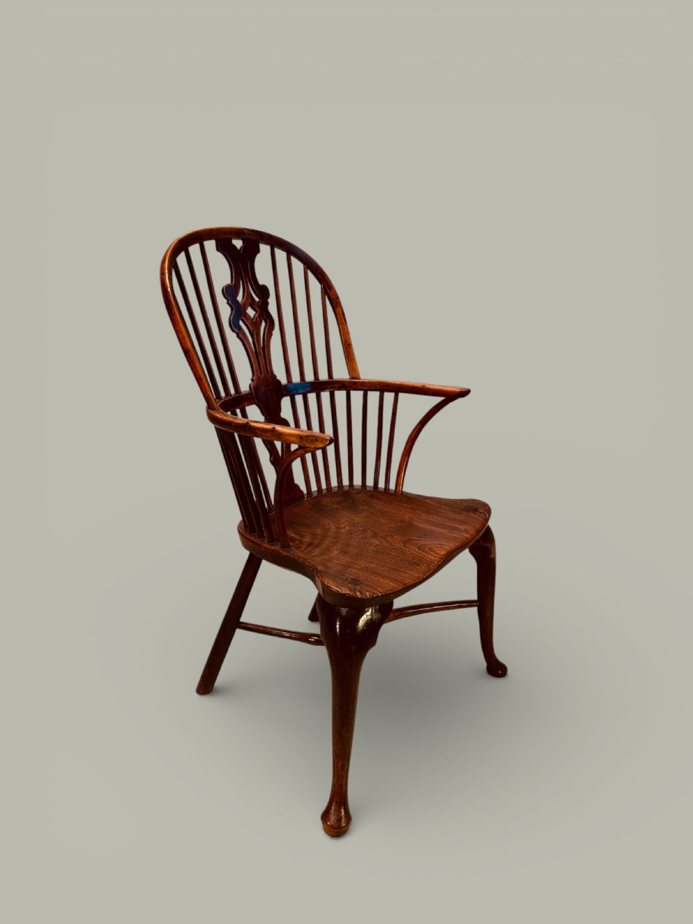 An eighteenth-century Windsor armchair crafted from yew wood and elm featuring a curved hoop back, pierced splat, shaped saddle seat, and cabriole front legs. View II