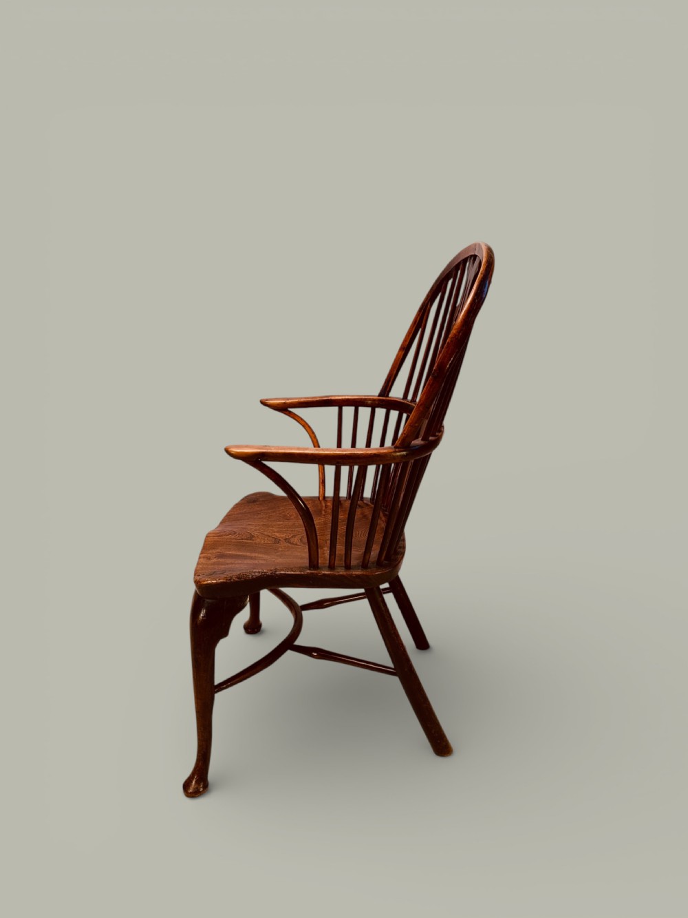 An eighteenth-century Windsor armchair crafted from yew wood and elm featuring a curved hoop back, pierced splat, shaped saddle seat, and cabriole front legs. View IV