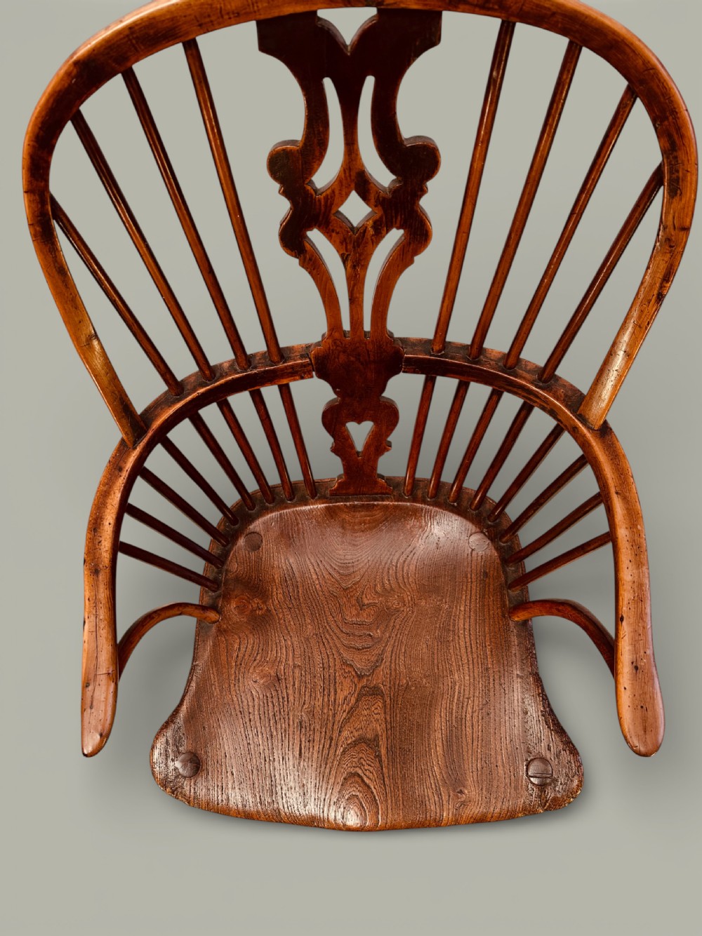 An eighteenth-century Windsor armchair crafted from yew wood and elm featuring a curved hoop back, pierced splat, shaped saddle seat, and cabriole front legs. View VI