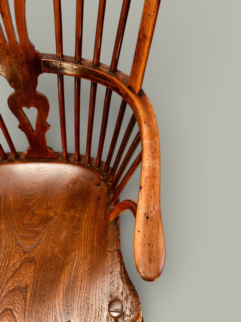 An eighteenth-century Windsor armchair crafted from yew wood and elm featuring a curved hoop back, pierced splat, shaped saddle seat, and cabriole front legs. View VII