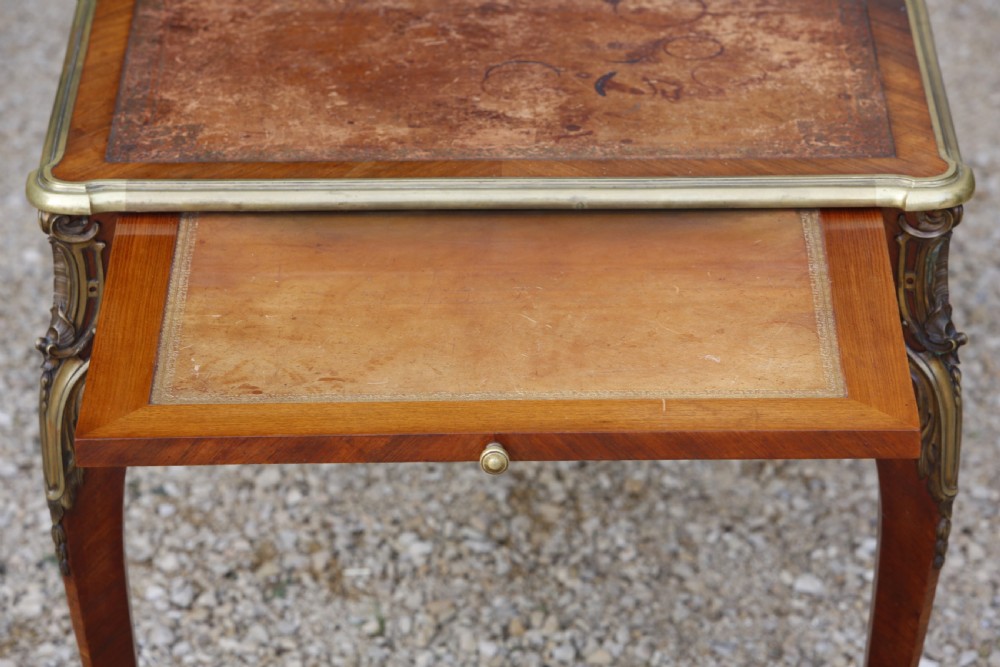 A Louis XV style bureau plat writing desk crafted from rosewood and tulipwood parquetry veneer, featuring gilt-bronze mounts, cabriole legs, three frieze drawers, and a leather-inset writing top. View VII