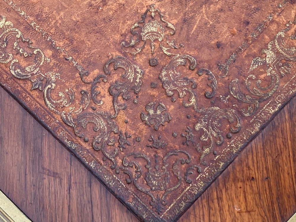 A Louis XV style bureau plat writing desk crafted from rosewood and tulipwood parquetry veneer, featuring gilt-bronze mounts, cabriole legs, three frieze drawers, and a leather-inset writing top. View XVII