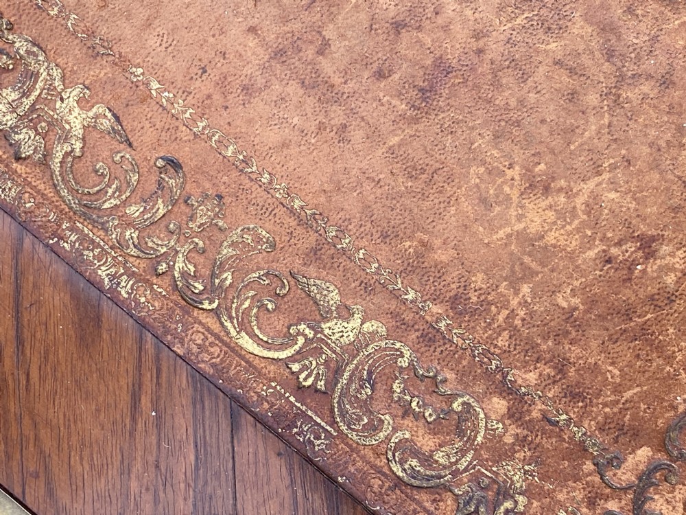 A Louis XV style bureau plat writing desk crafted from rosewood and tulipwood parquetry veneer, featuring gilt-bronze mounts, cabriole legs, three frieze drawers, and a leather-inset writing top. View XVIII