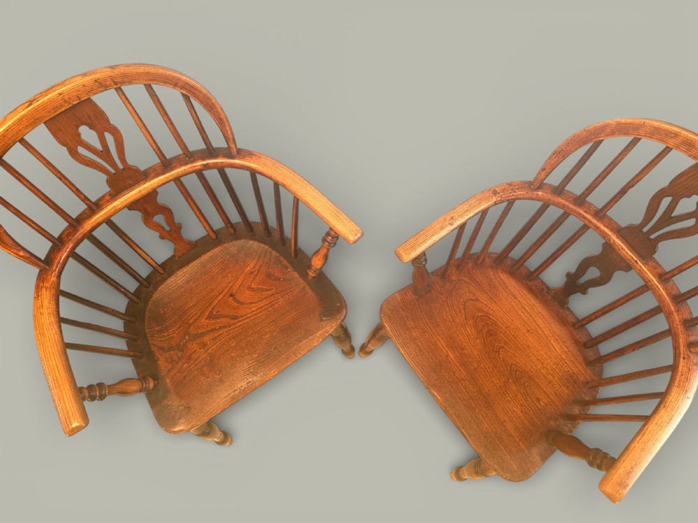 A set of twelve antique low back Windsor armchairs crafted from warm brown ash and elm with turned legs and hoop backs. View III