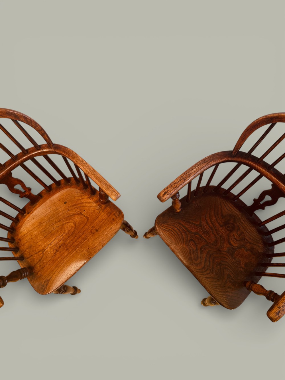 A set of twelve antique low back Windsor armchairs crafted from warm brown ash and elm with turned legs and hoop backs. View VII