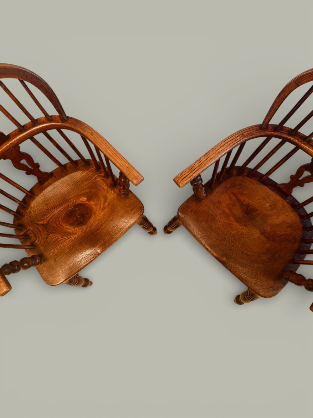 A set of twelve antique low back Windsor armchairs crafted from warm brown ash and elm with turned legs and hoop backs. View IX